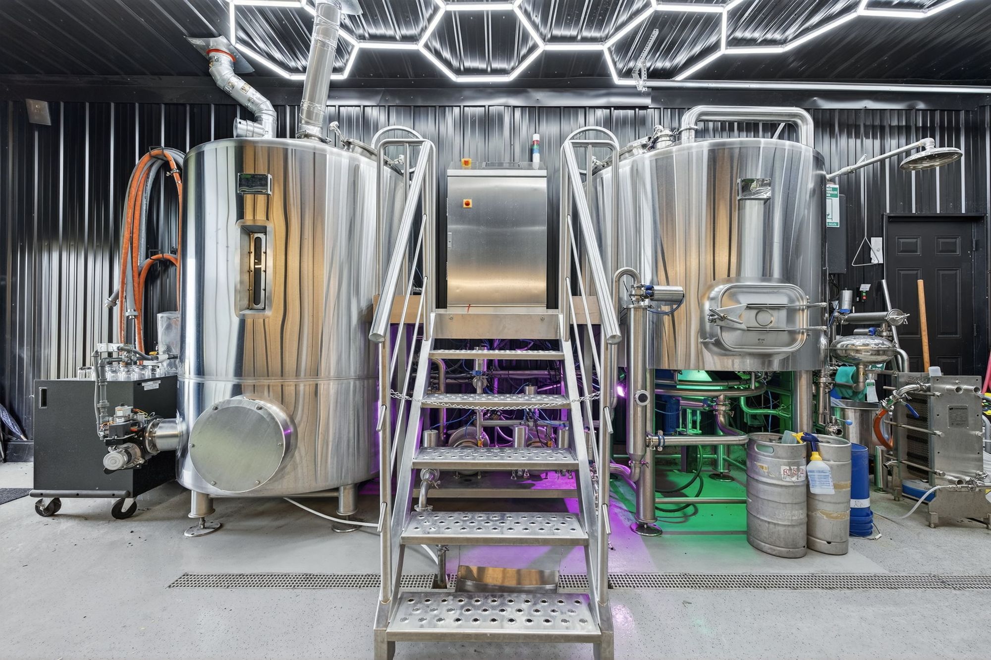 The brewhouse kettles and stairs under hexagon lighting