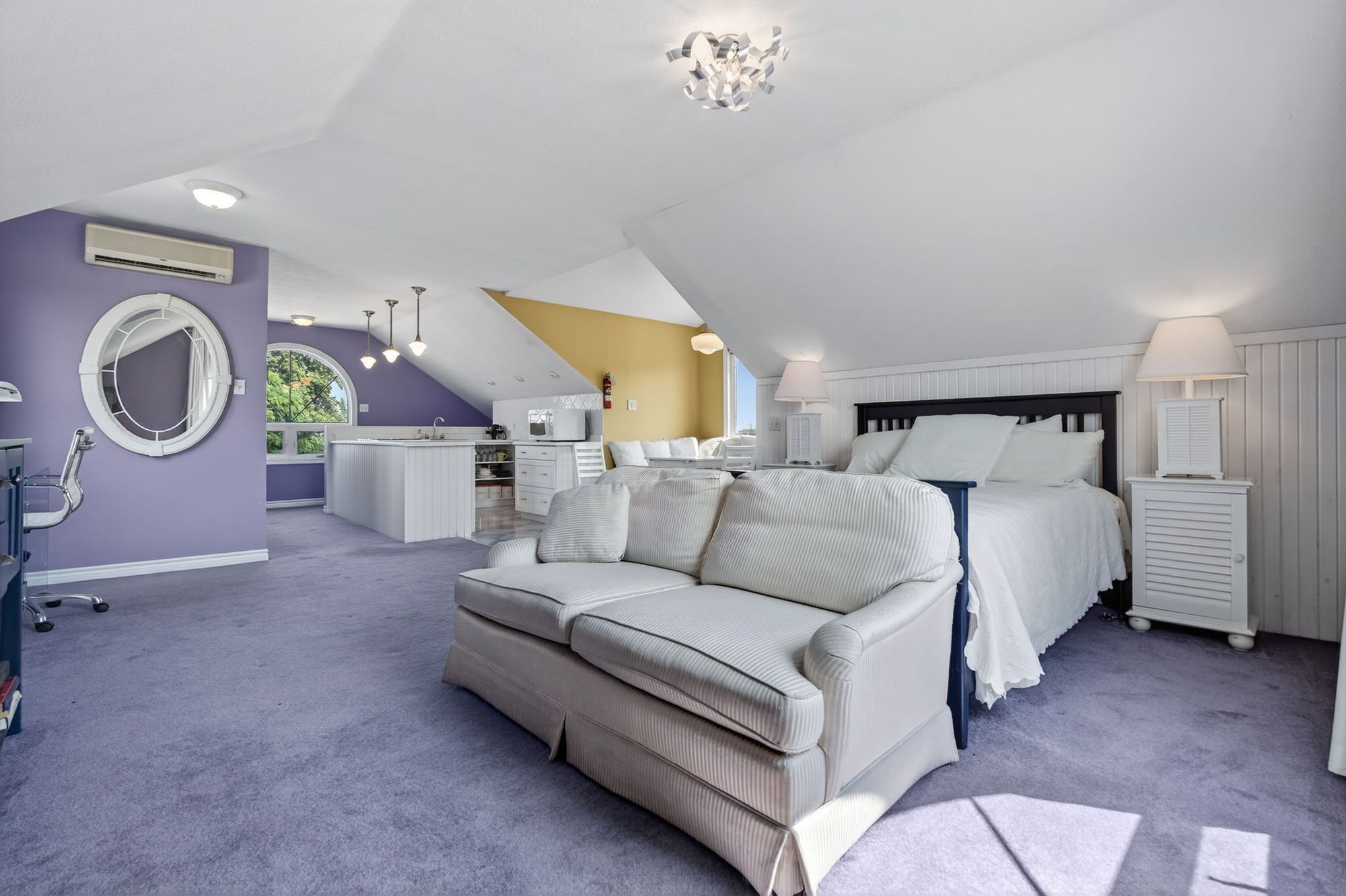 The guest suite's bedroom and sitting area under the eaves