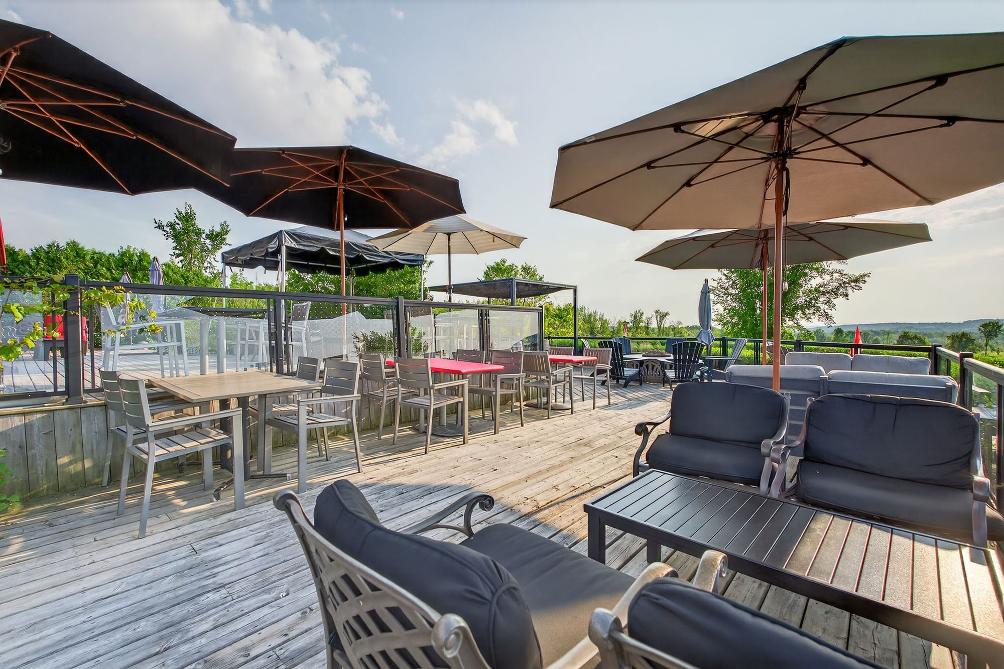 The deck's umbrellas and lounge chairs looking out over the hills