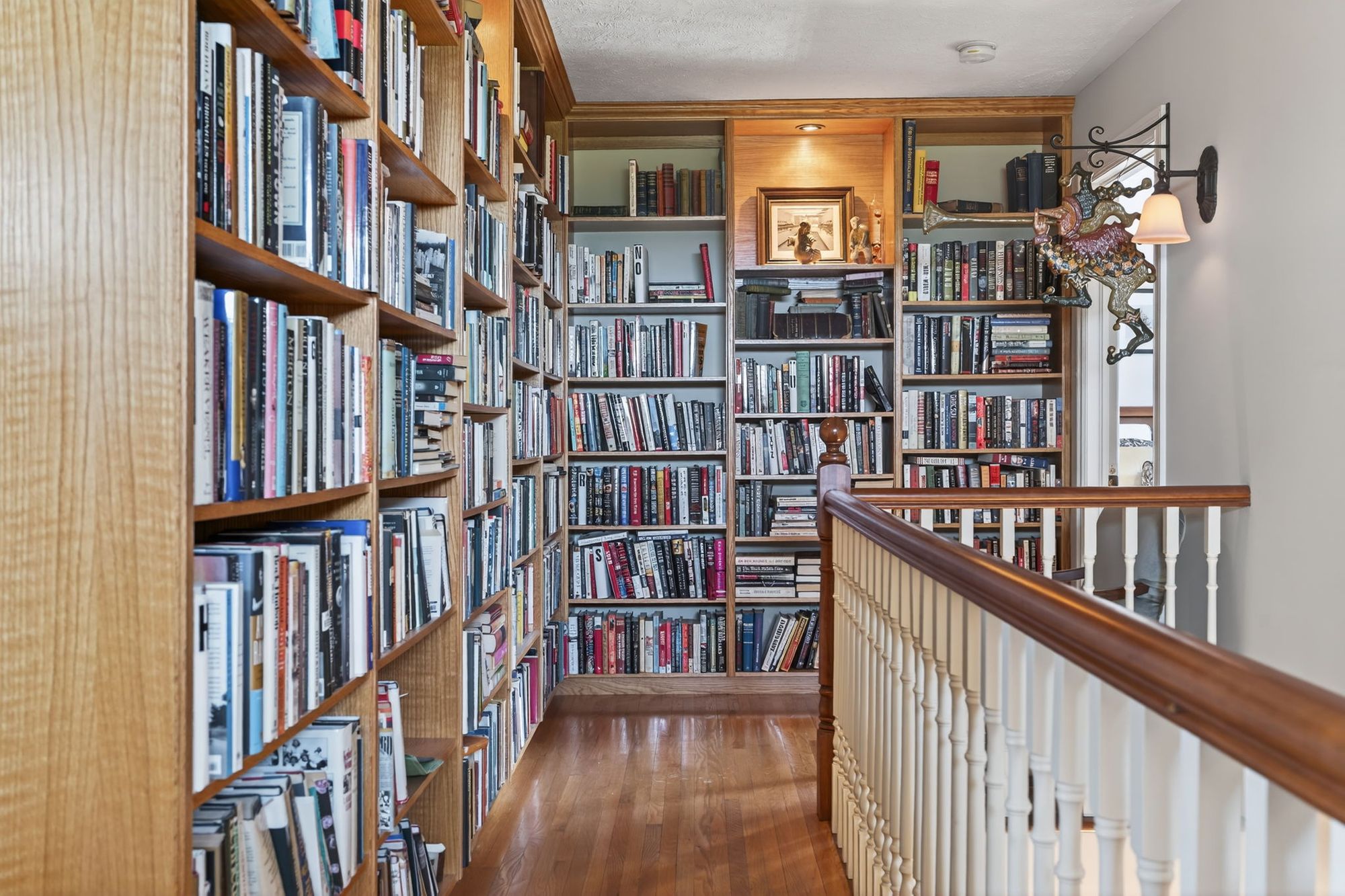 The upstairs landing lined with bookshelves