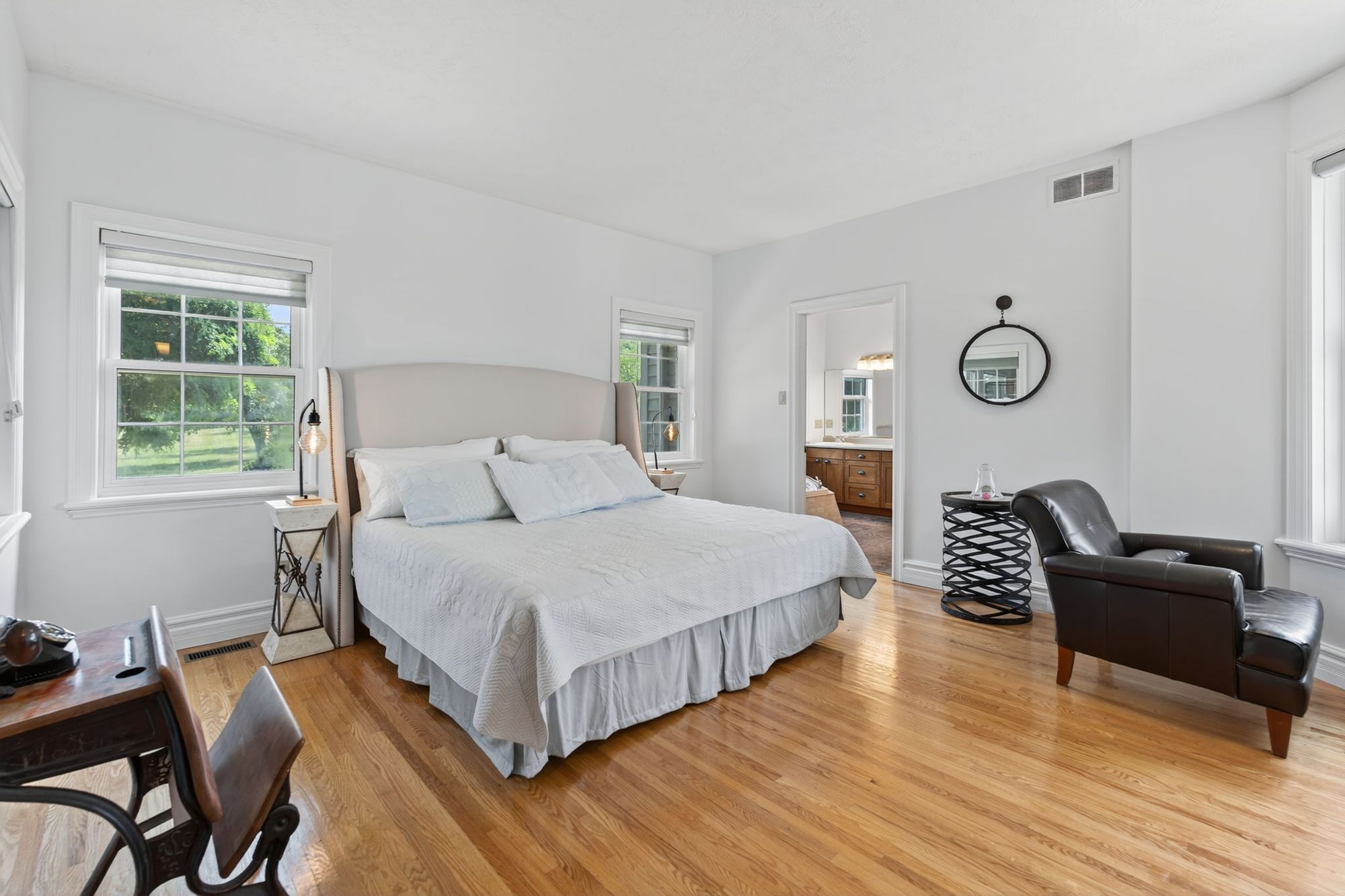 A bedroom with French doors and a sitting area