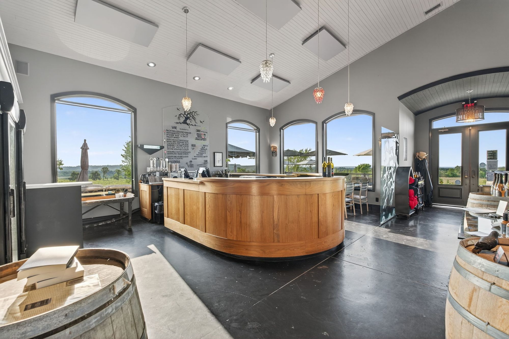 The curved wooden tasting bar under the high ceiling
